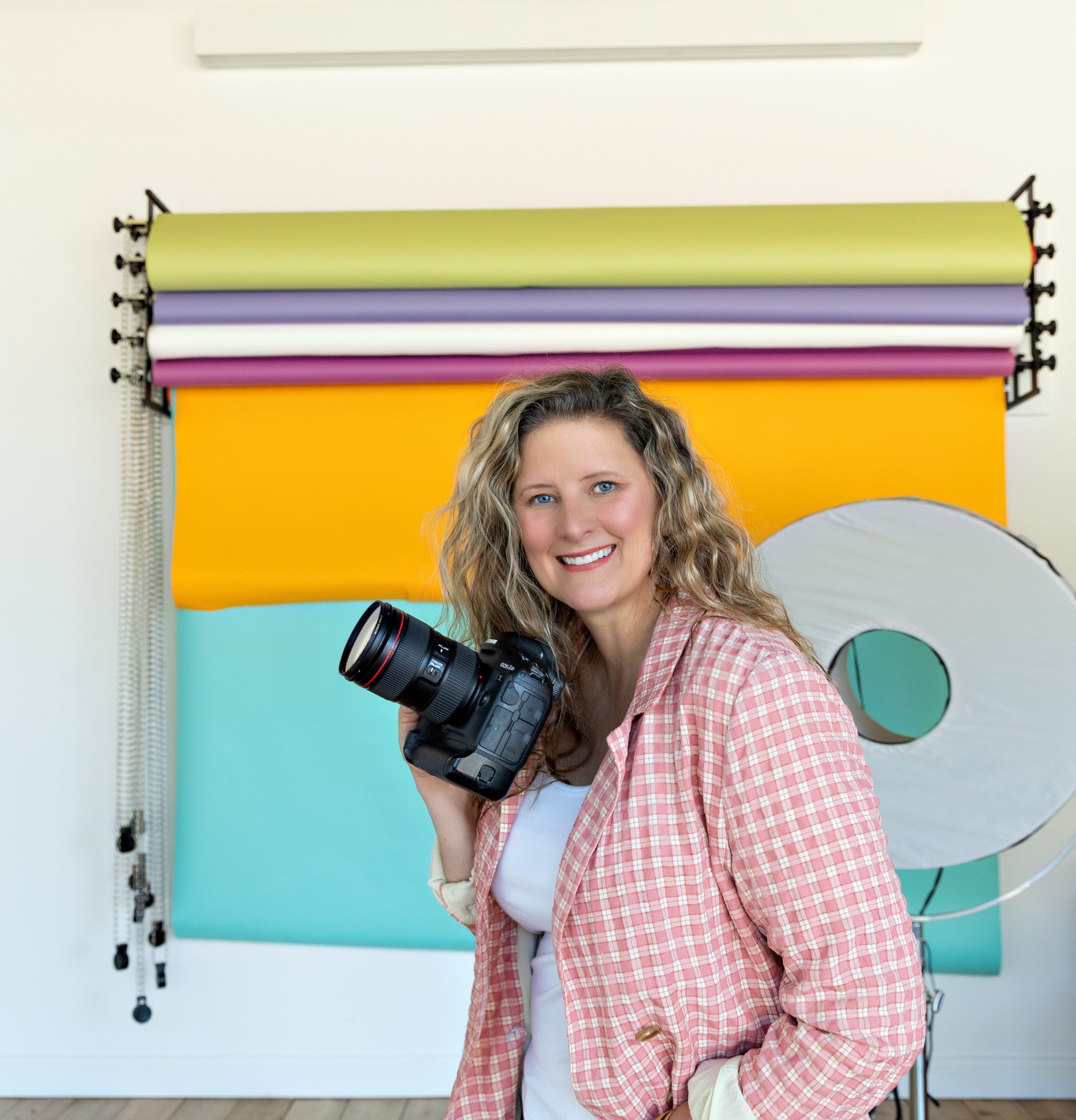 Sarah Petty Holding Camera Smiling Studio Equipment