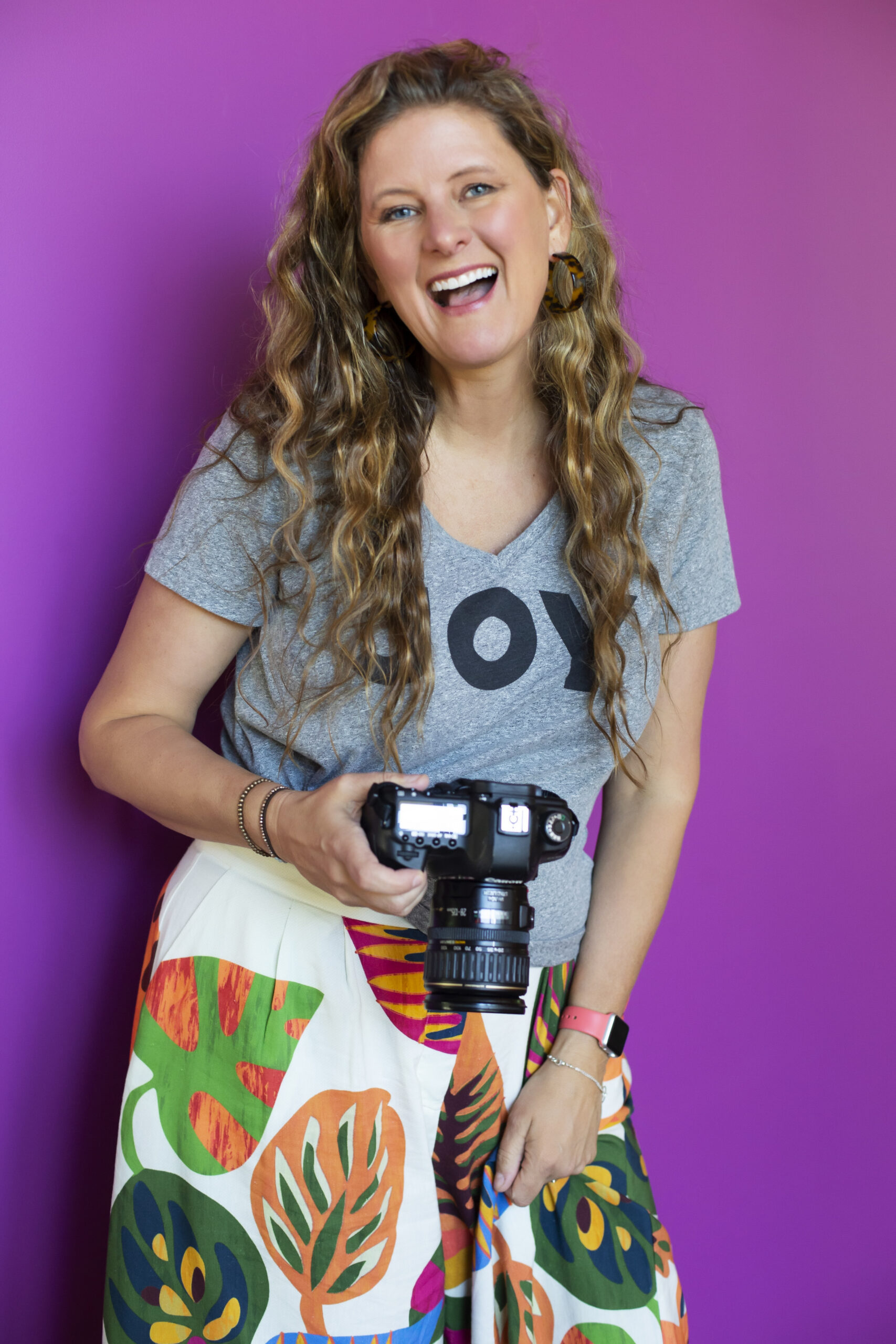 Sarah Laughing with Camera Purple Background