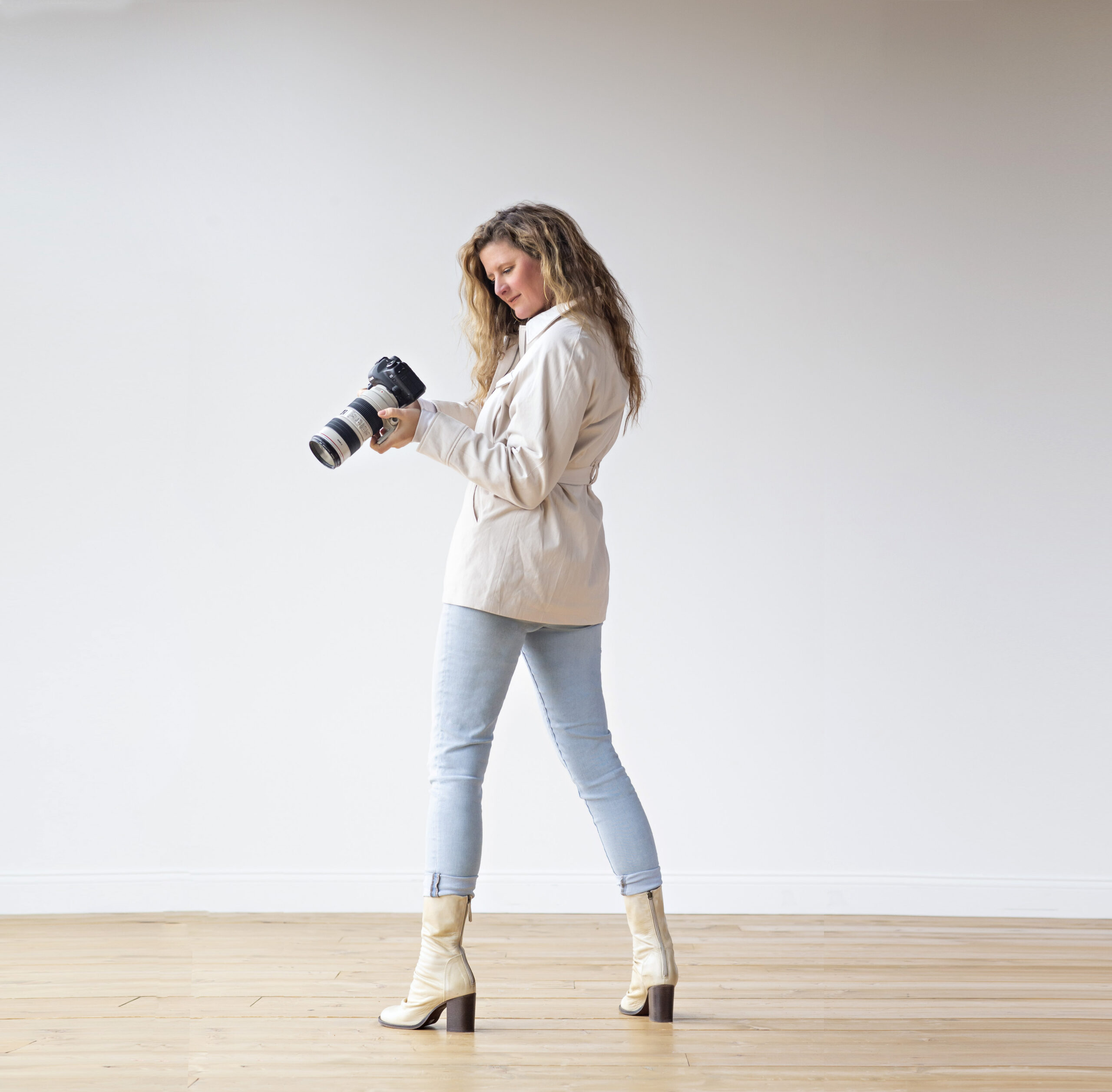 Sarah in boots with camera in studio