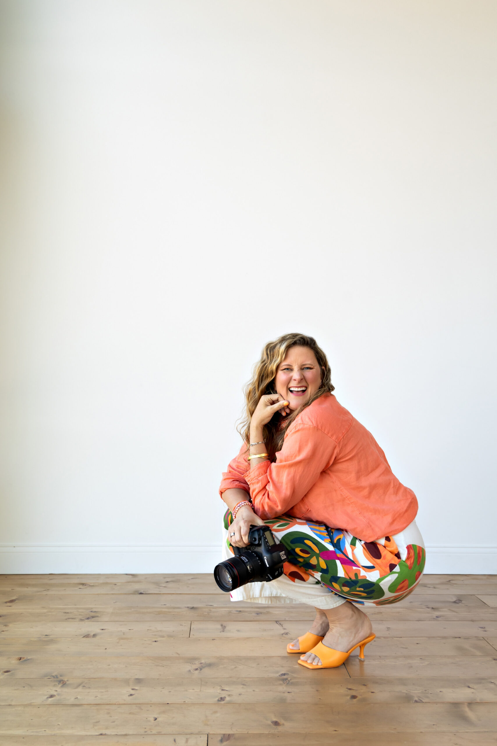 Sarah Petty Crouching White Space Laughing