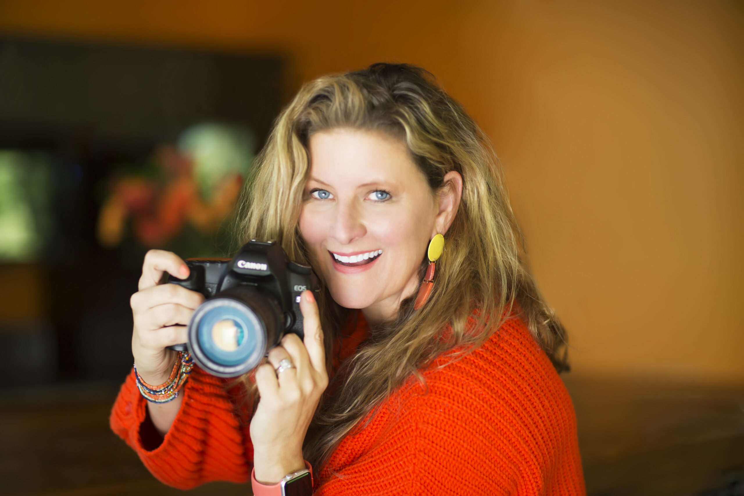Sarah with camera yellow background ()